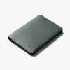 Green leather wallet with visible brand name on a white background