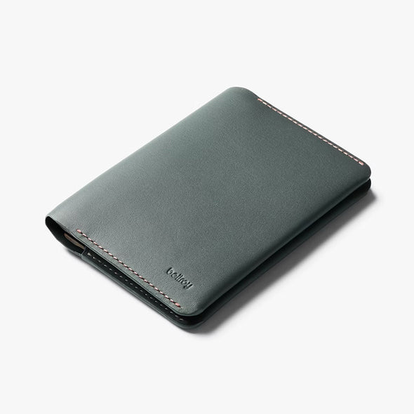 Green leather wallet with visible brand name on a white background