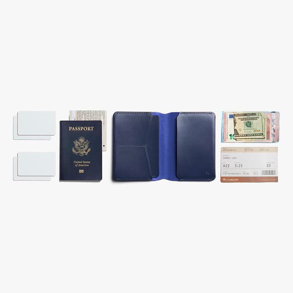 Blue passport holder with various travel documents on a white background