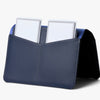 Blue leather cardholder with two cards on a white background
