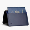 Navy blue passport holder with a passport inside on a white background