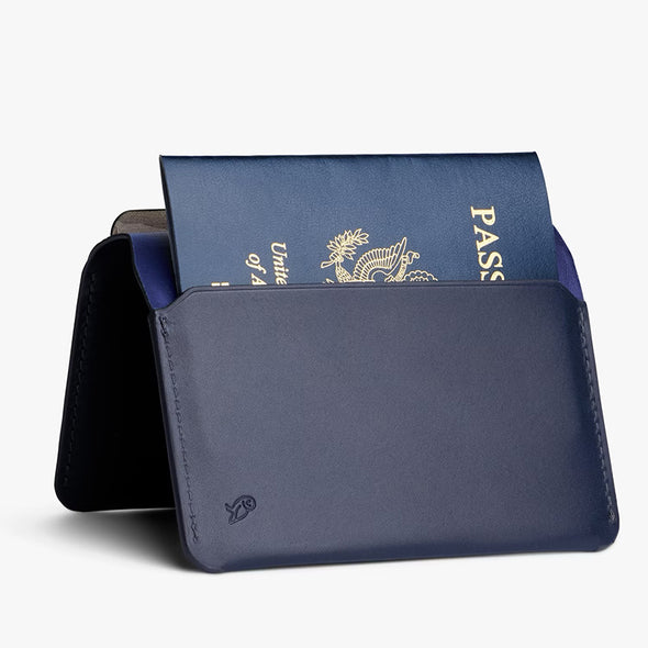 Navy blue passport holder with a passport inside on a white background