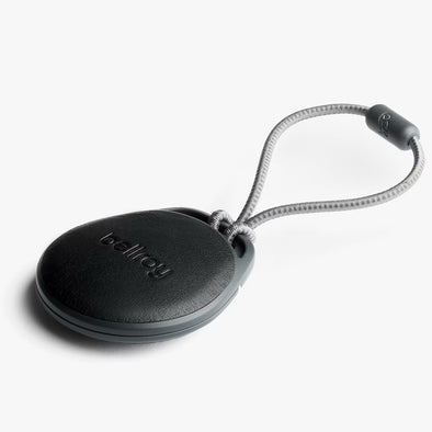 Black keychain device with a cord on a white background