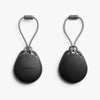Two black keychain devices with rope loops on a white background, featuring the Bellroy brand.