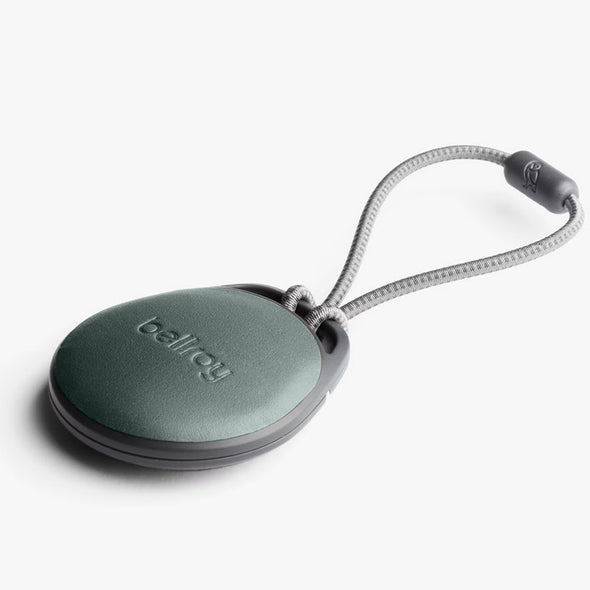 Green keychain device with a rope on a white background