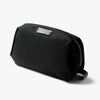 Black toiletry bag with a silver zipper on a white background