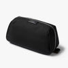 Black toiletry bag with a brand logo on a white background
