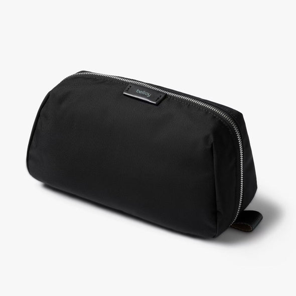 Black toiletry bag with a brand logo on a white background