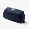 Navy blue toiletry bag with a brand label on a white background