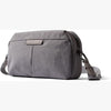 Gray shoulder bag with a visible brand logo on a white background