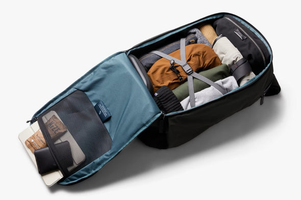 Open Bellroy Transit Workpack Pro 28L Olive with travel items on a white background