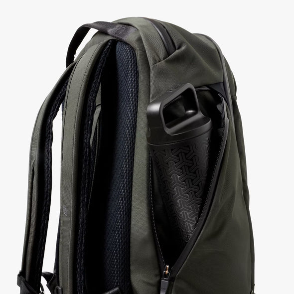 Green backpack with a water bottle holder on a white background