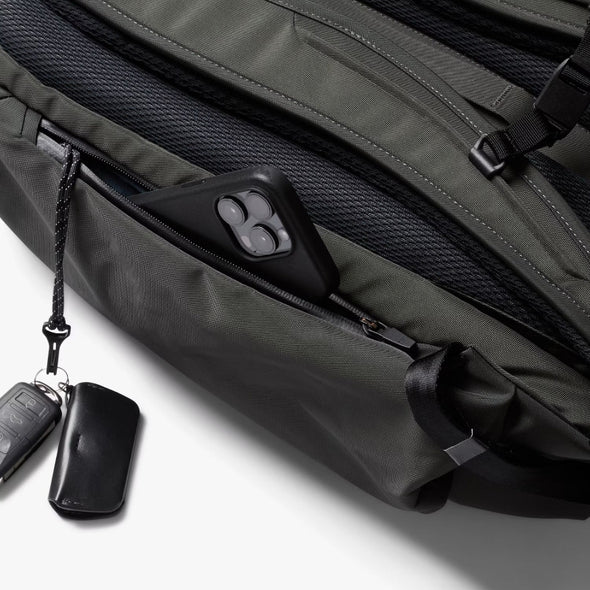 Bellroy Transit Workpack Pro 28L Olive backpack with a keychain attached on a white background