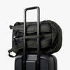 Bellroy Transit Workpack Pro 28L Olive backpack with a handle on top of a black suitcase