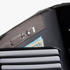 Close-up of a gray wallet with a zipper pocket holding money.