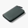 Green leather wallet on a light gray background