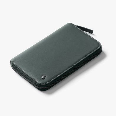 Green leather wallet on a light gray background