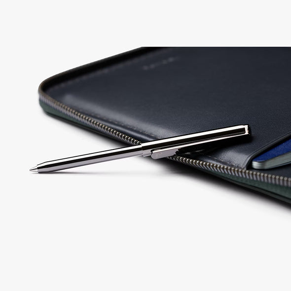Silver pen on a black leather surface