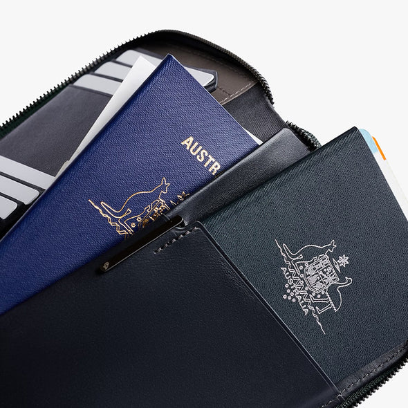 Passport holder with Australian passport and other travel documents on a white background