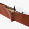 Brown leather wallet with card slots and a pen on a white background