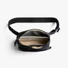 Black waist bag with a zipper on a white background