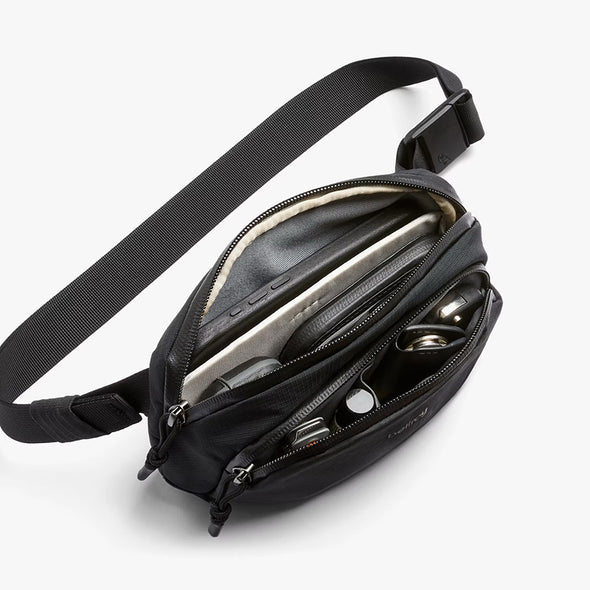 Black waist bag with multiple compartments on a white background