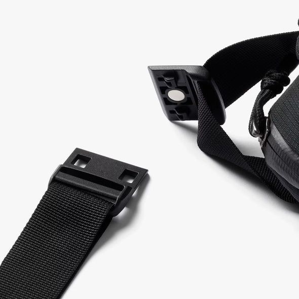 Close-up of a black belt with a buckle on a white background