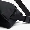 Black waist bag with a strap on a white background