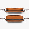 Two brown bags with leather straps on a white background