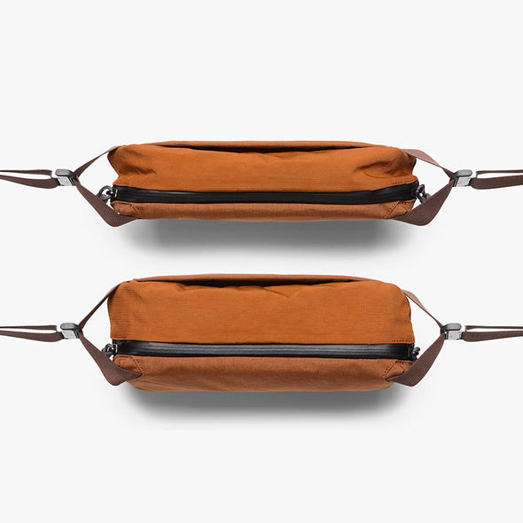 Two brown bags with leather straps on a white background