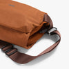 Brown bag with a strap on a white background