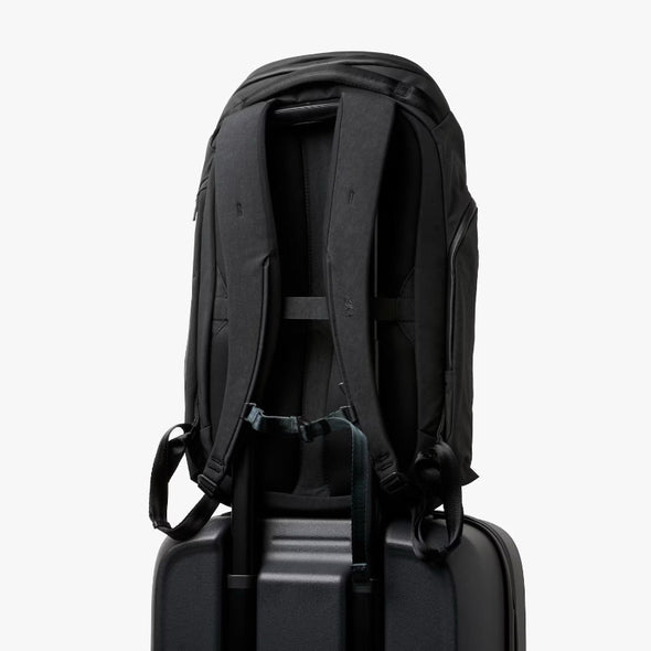Bellroy Venture Travel Pack 26L Jet Black sits on top of a suit case
