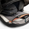 Open backpack with compartments and zippers on a white background