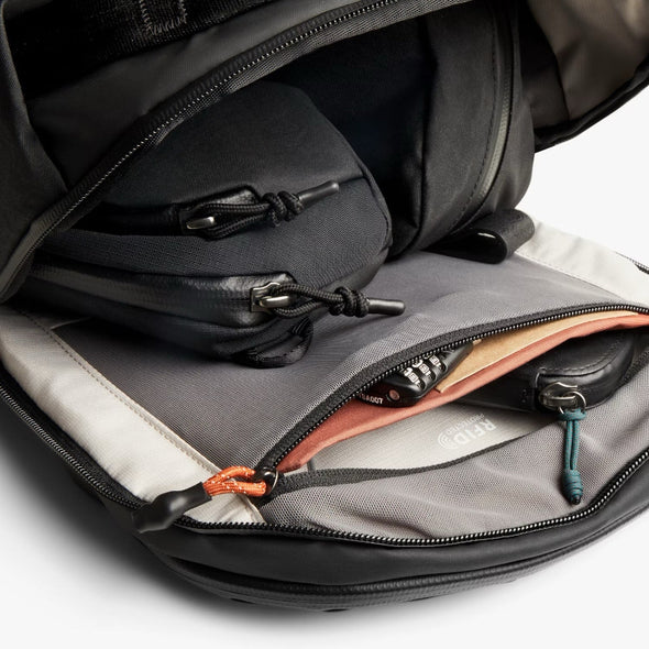 Open backpack with compartments and zippers on a white background