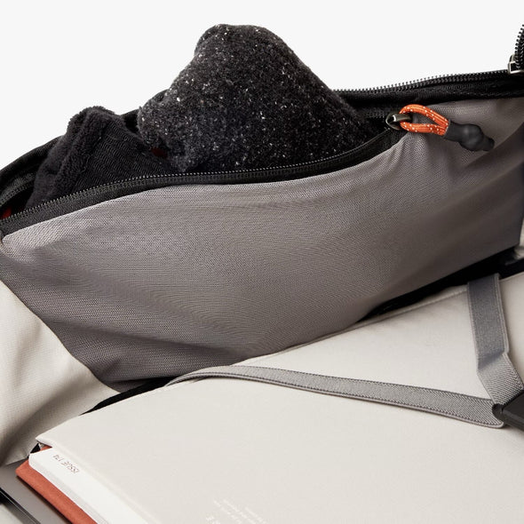 Gray bag with black item inside, on a white background