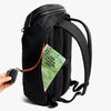 Black backpack with a map and device on a white background