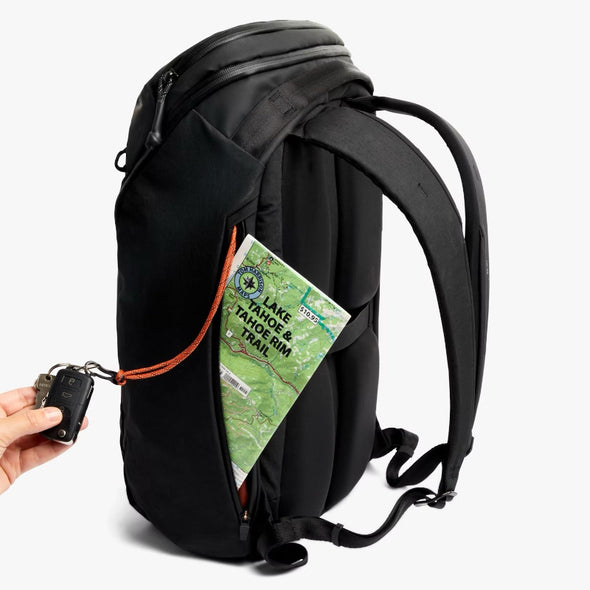 Black backpack with a map and device on a white background