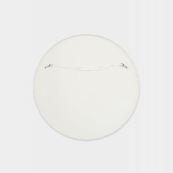 back of a Round white mirror showing hanging points and cord on a light grey background