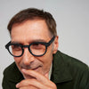 Man wearing black IZIPIZI Reading Glasses Collection #C with a neutral background