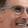 Close-up of a person wearing IZIPIZI Reading Glasses Collection #C in Frozen Blue with a focus on the glasses.