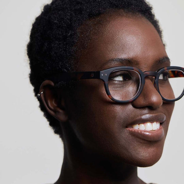Woman wearing IZIPIZI Reading Glasses Collection #C Tortoise with a neutral background