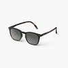 Sunglasses with tortoiseshell frame and dark lenses on a white background