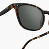 Sunglasses with tortoiseshell frame and dark lenses on a white background