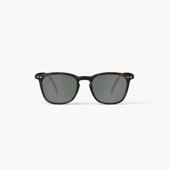Sunglasses with tortoiseshell frame and dark lenses on a white background