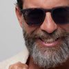 Man wearing sunglasses with a neutral background