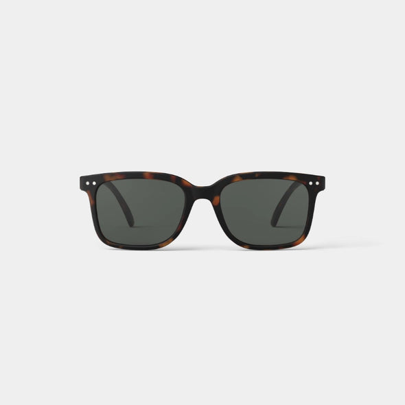 Sunglasses with tortoiseshell frame and dark lenses on a white background
