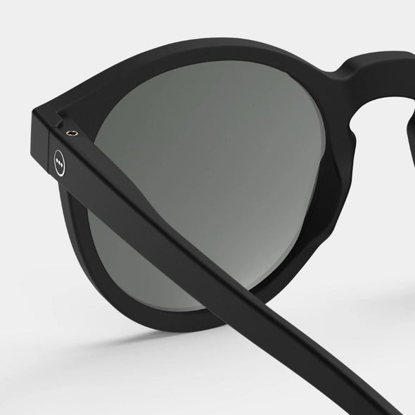 Black sunglasses with a gray lens on a white background