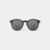 Black sunglasses with dark lenses on a light gray background