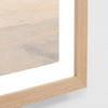Close-up of a wooden frame with a glass panel on a white background