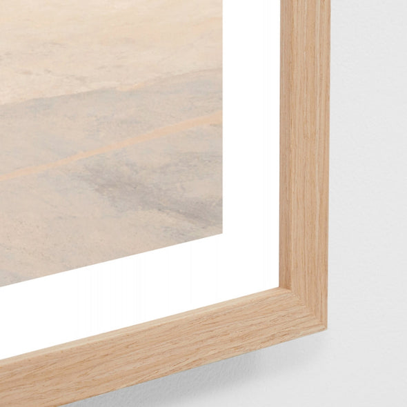 Close-up of a wooden frame with a glass panel on a white background